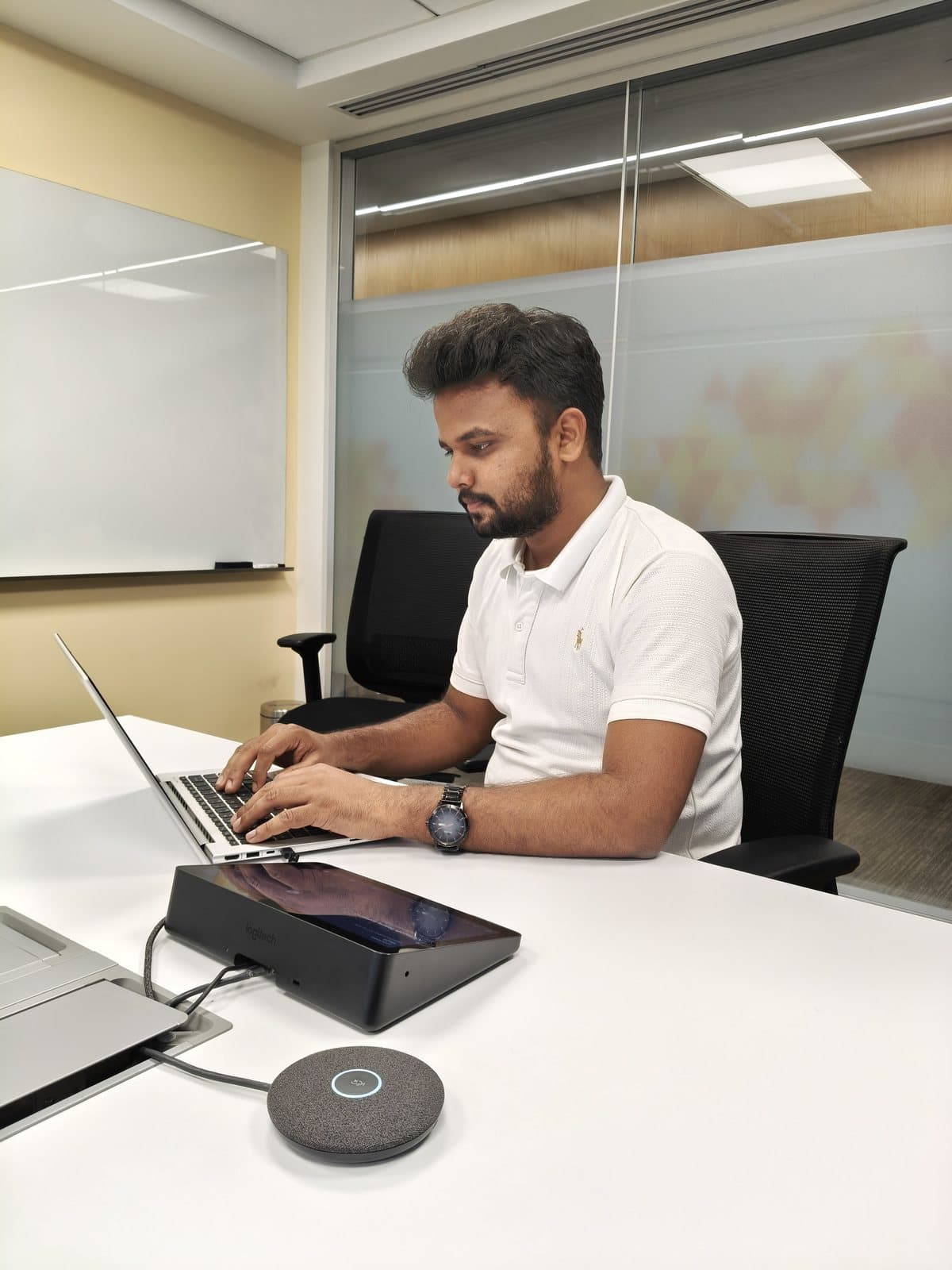 Samir Alam working on a laptop